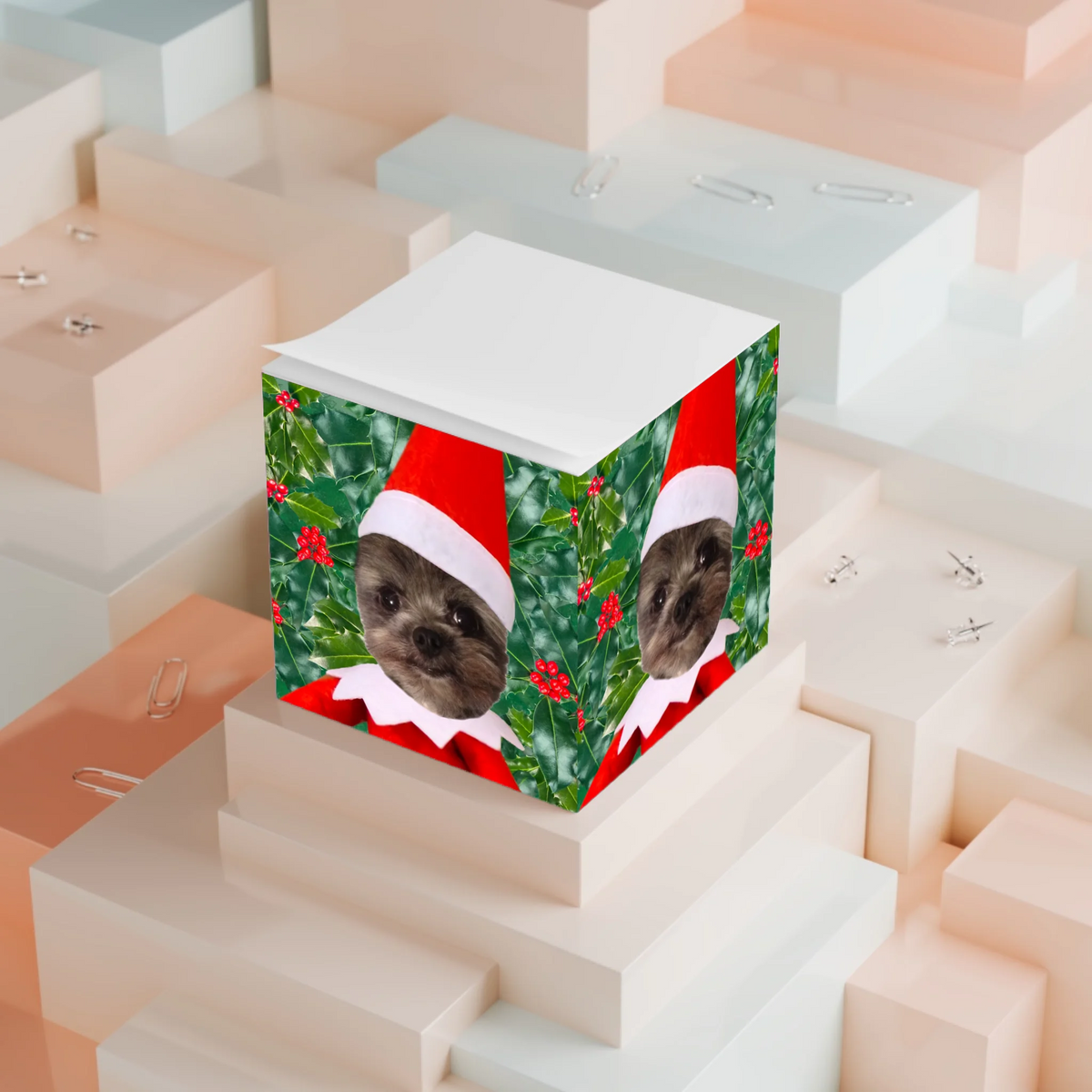 Official Elf Business note cube with an elf-dressed dog photo, displayed on stacked paper blocks
